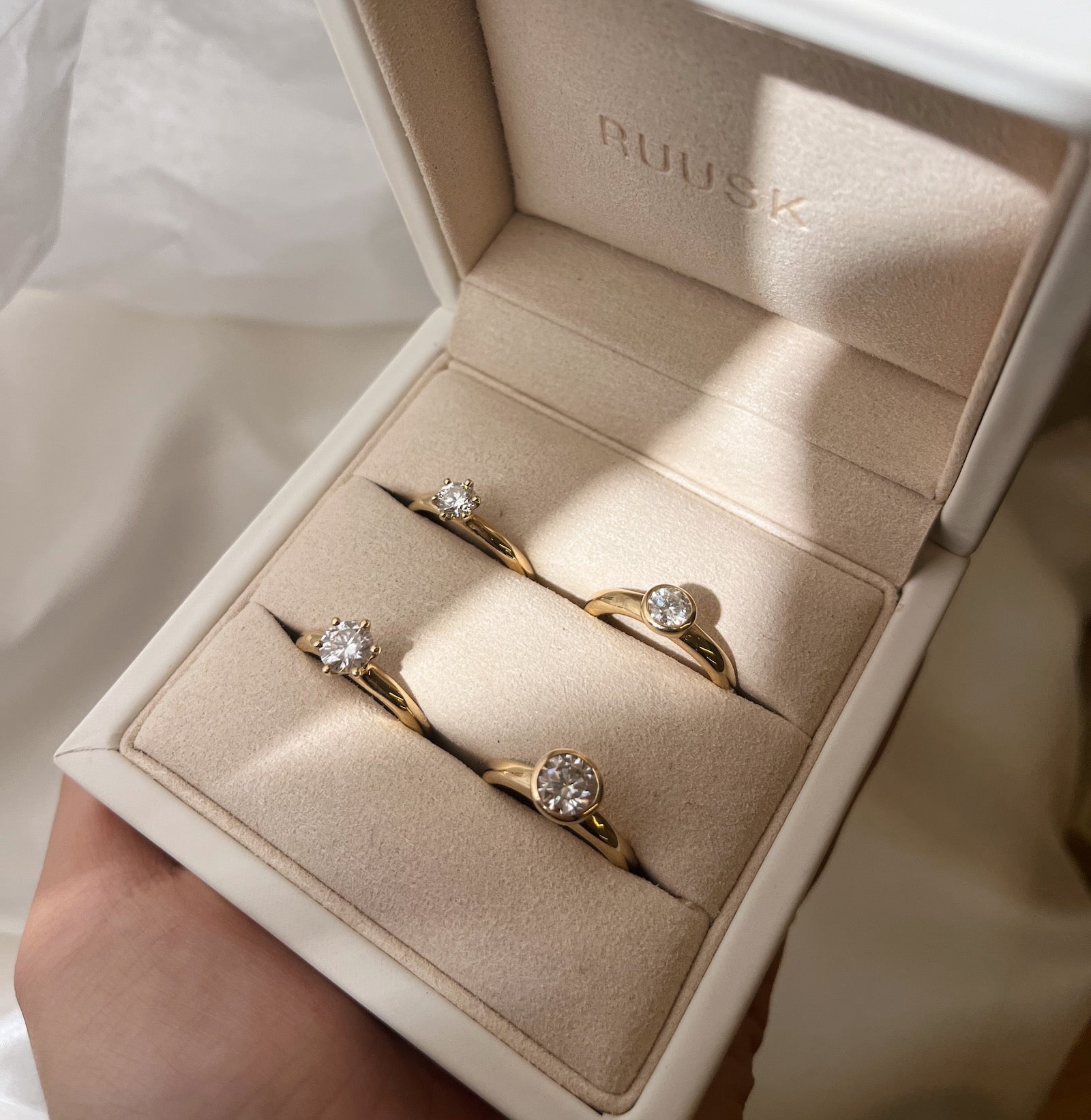 claw and bezel set rings in a box
