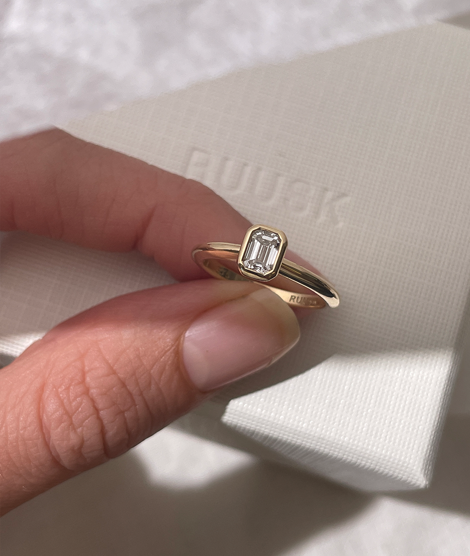 Emerald Cut Diamond bezel set Solitaire ring, cast in solid Gold. Handcrafted to order in Sydney Australia. Minimal Diamond Engagement ring ideal for stacking with other bands. Custom engagement and wedding rings.