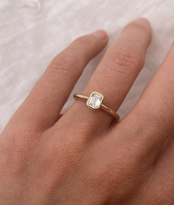 Emerald Cut Diamond bezel set Solitaire ring, cast in solid Gold. Handcrafted to order in Sydney Australia. Minimal Diamond Engagement ring ideal for stacking with other bands. Custom engagement and wedding rings.
