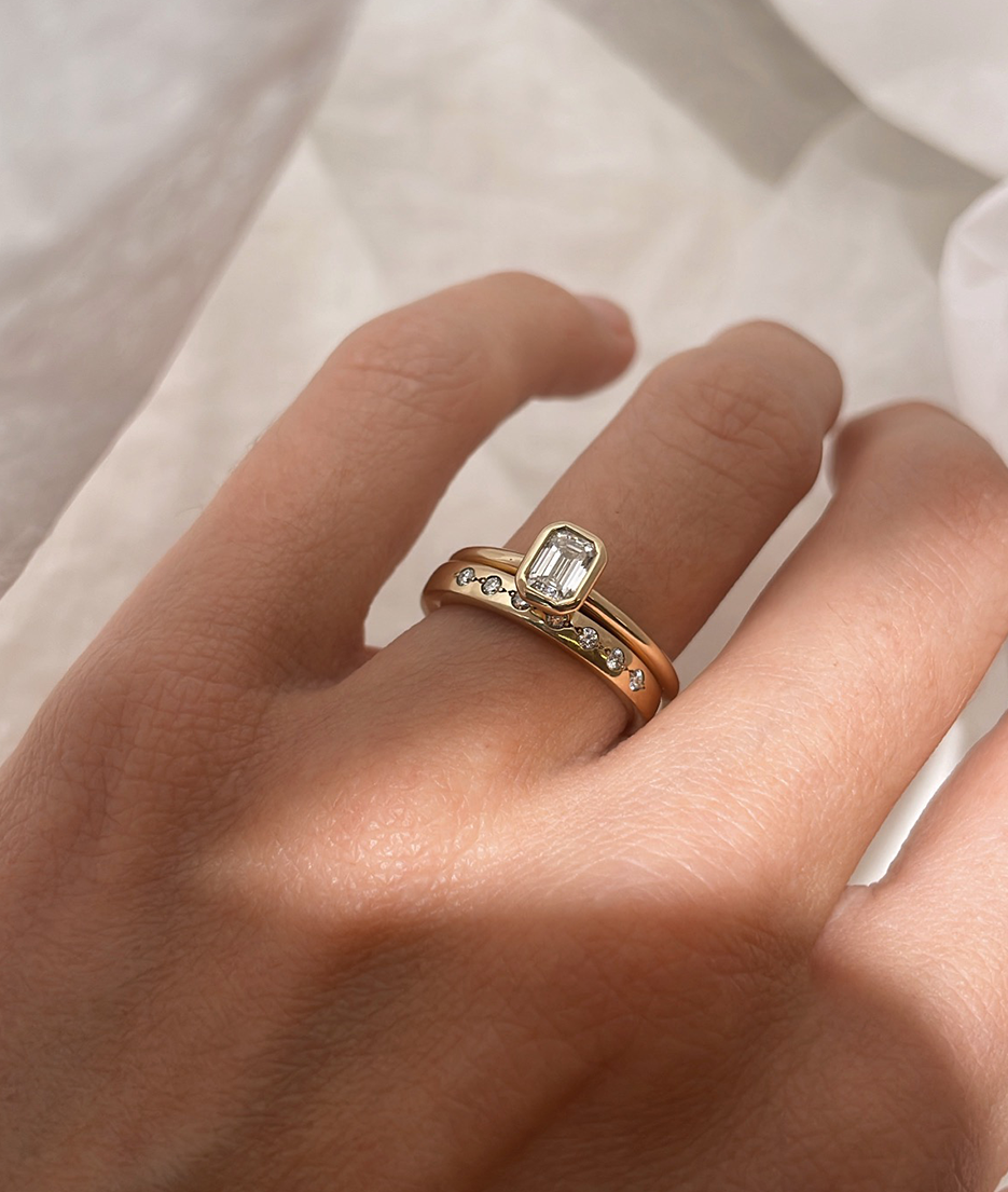 Emerald Cut Diamond bezel set Solitaire ring, cast in solid Gold. Handcrafted to order in Sydney Australia. Minimal Diamond Engagement ring ideal for stacking with other bands. Custom engagement and wedding rings.