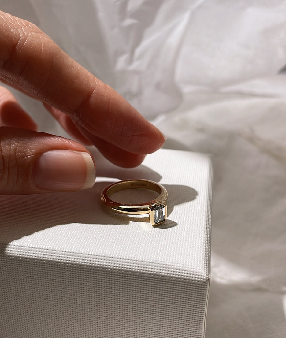 Emerald Cut Diamond bezel set Solitaire ring, cast in solid Gold. Handcrafted to order in Sydney Australia. Minimal Diamond Engagement ring ideal for stacking with other bands. Custom engagement and wedding rings.