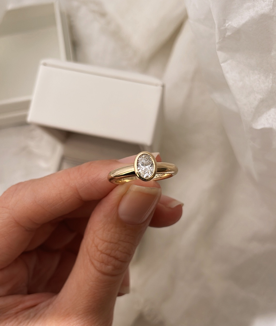 Hand carved oval bezel set Solitaire ring, cast in solid Gold. Handcrafted to order in Sydney Australia. Minimal Diamond Engagement ring ideal for stacking with other bands. Custom engagement and wedding rings.