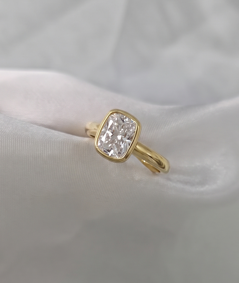 A solid gold cushion cut diamond Solitaire ring with.