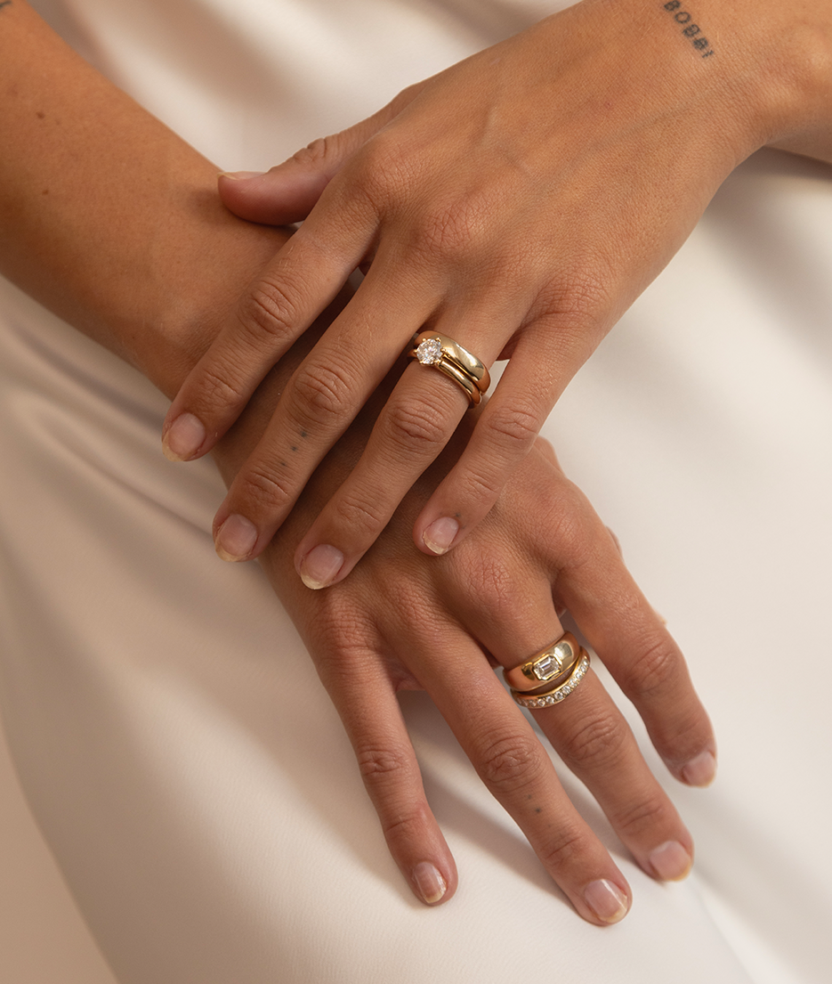 1ct Claw-Set Solitaire Editorial Image with other gold diamond ring stacks