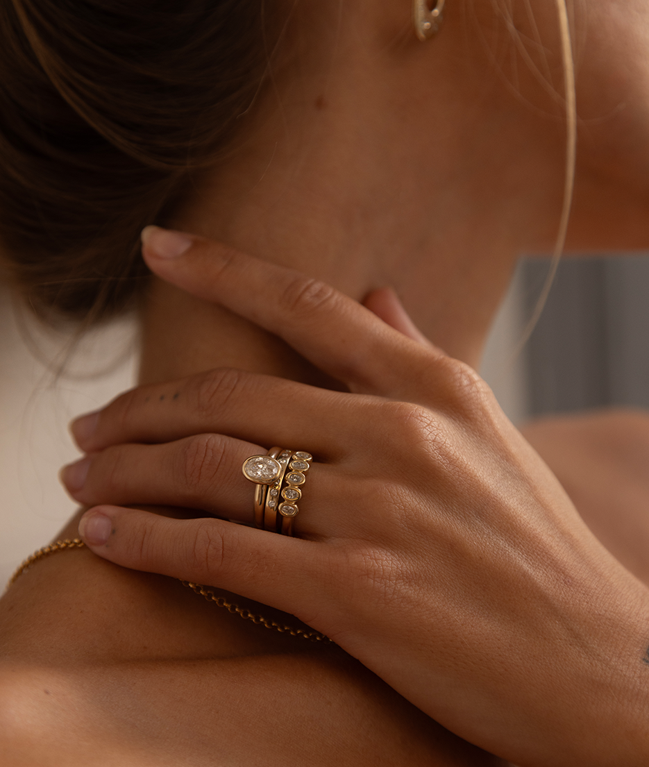 Hand carved oval bezel set Solitaire ring, cast in solid Gold. Handcrafted to order in Sydney Australia. Minimal Diamond Engagement ring ideal for stacking with other bands. Custom engagement and wedding rings.