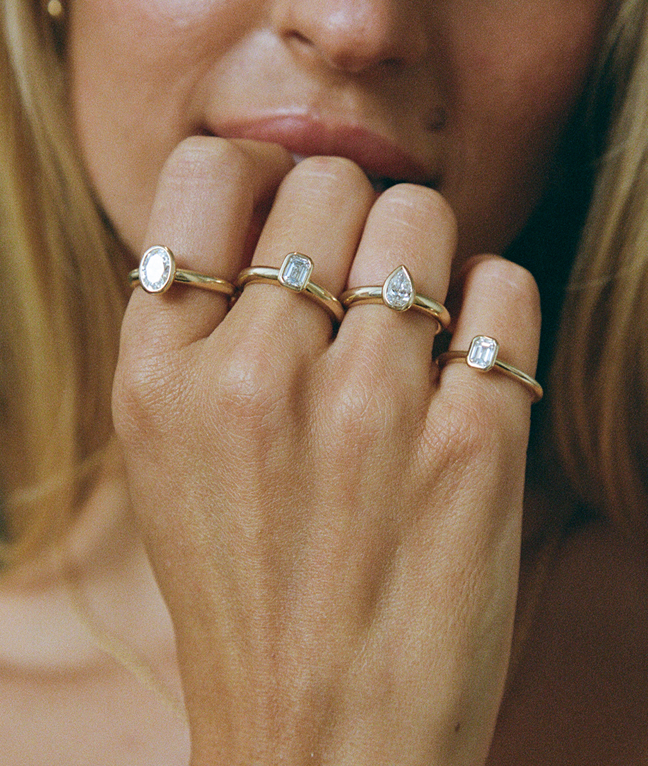 Diamond bezel set Solitaire rings with pear, oval and emerald cut stone shapes, cast in solid Gold. Handcrafted to order in Sydney Australia. Minimal Diamond Engagement ring ideal for stacking with other bands. Custom engagement and wedding rings.