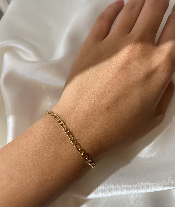 Solid Gold Figaro Chain Bracelet On Hand