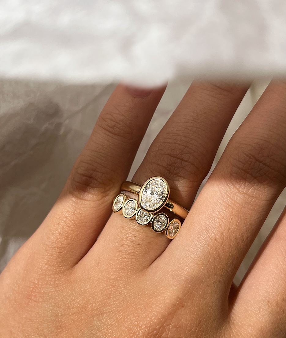 Handmade Oval Medium 5 Suns Ring in solid gold. Hand crafted to order in Sydney. Meaningful heirlooms, engagement rings and wedding bands for the Modern bride. Conscious jewellery. Paired with 0.8ct Oval Solitaire
