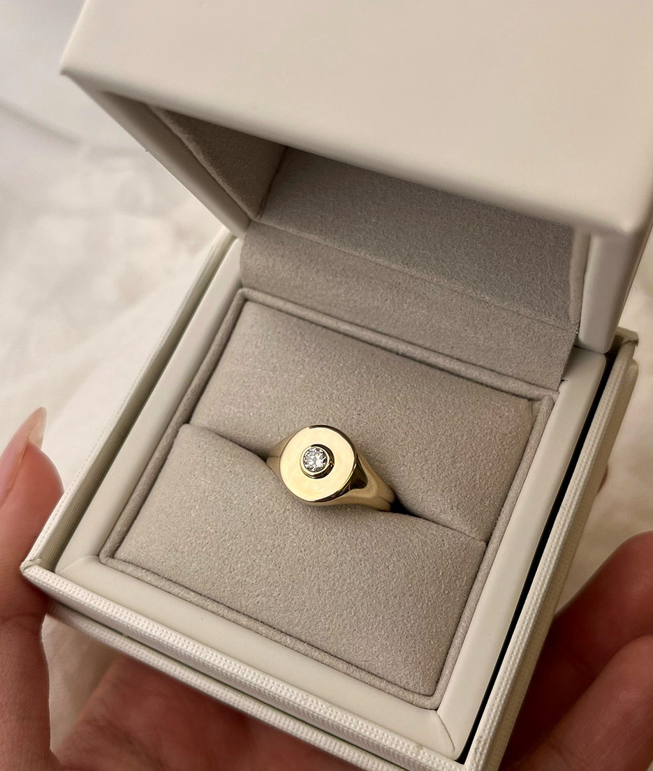 Handmade solid gold womens signet ring featuring a conflict-free Diamond. Round diamond bezel set in the centre of the signet face, cast in solid Gold. Made to order in Sydney Australia. Bespoke and Custom rings for the modern woman and bride.