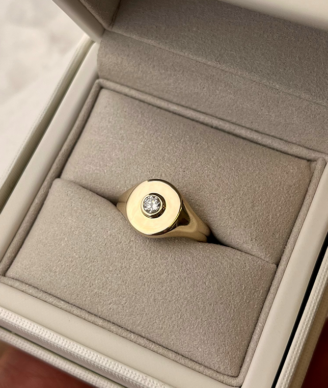 Handmade solid gold womens signet ring featuring a conflict-free Diamond. Round diamond bezel set in the centre of the signet face, cast in solid Gold. Made to order in Sydney Australia. Bespoke and Custom rings for the modern woman and bride.