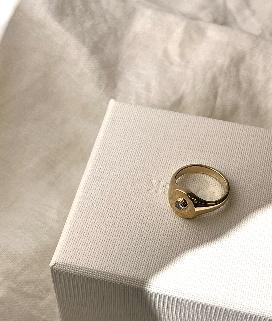 Handmade solid gold womens signet ring featuring a conflict-free Diamond. Round diamond bezel set in the centre of the signet face, cast in solid Gold. Made to order in Sydney Australia. Bespoke and Custom rings for the modern woman and bride.