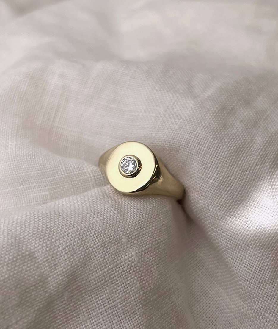 Handmade solid gold womens signet ring featuring a conflict-free Diamond. Round diamond bezel set in the centre of the signet face, cast in solid Gold. Made to order in Sydney Australia. Bespoke and Custom rings for the modern woman and bride.