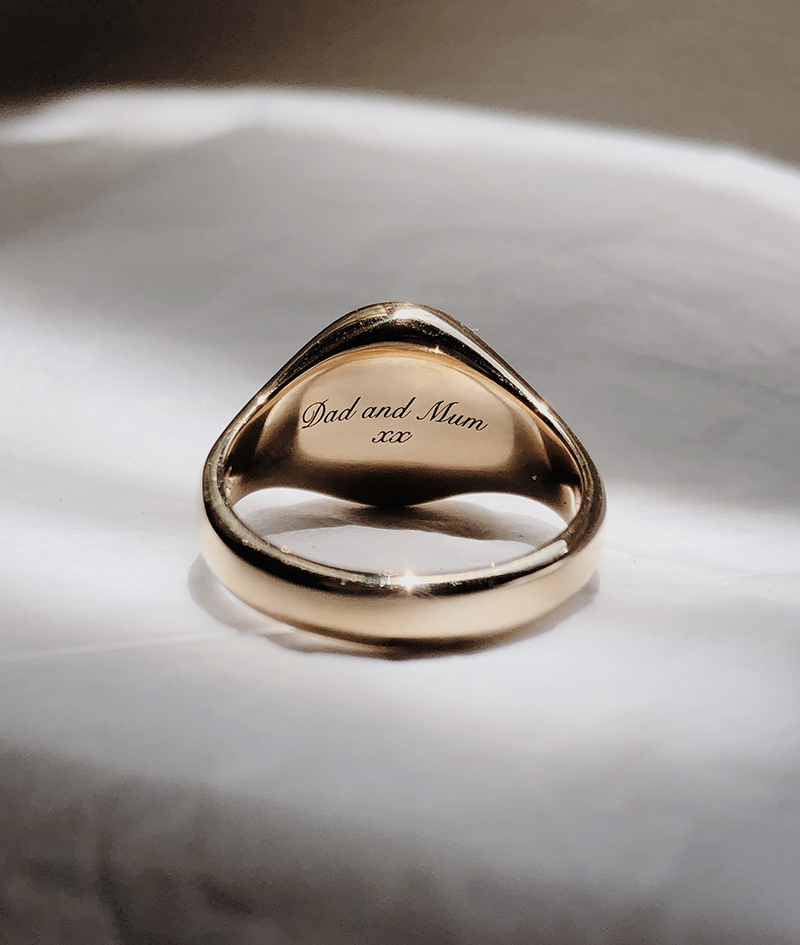 Oval Bezel-Set Small Signet Ring, cast in solid Gold. Handmade womens signet ring featuring a conflict-free Diamond. Cursive engraving inside ring band.Made to order in Sydney Australia. Bespoke and Custom rings for the modern woman and bride.