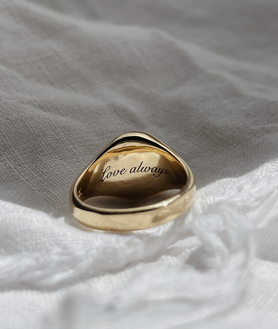 Handmade solid gold womens signet ring featuring a conflict-free Diamond. Round diamond bezel set in the centre of the signet face, cast in solid Gold with cursive engraving inside band. Made to order in Sydney Australia. Bespoke and Custom rings for the modern woman and bride.