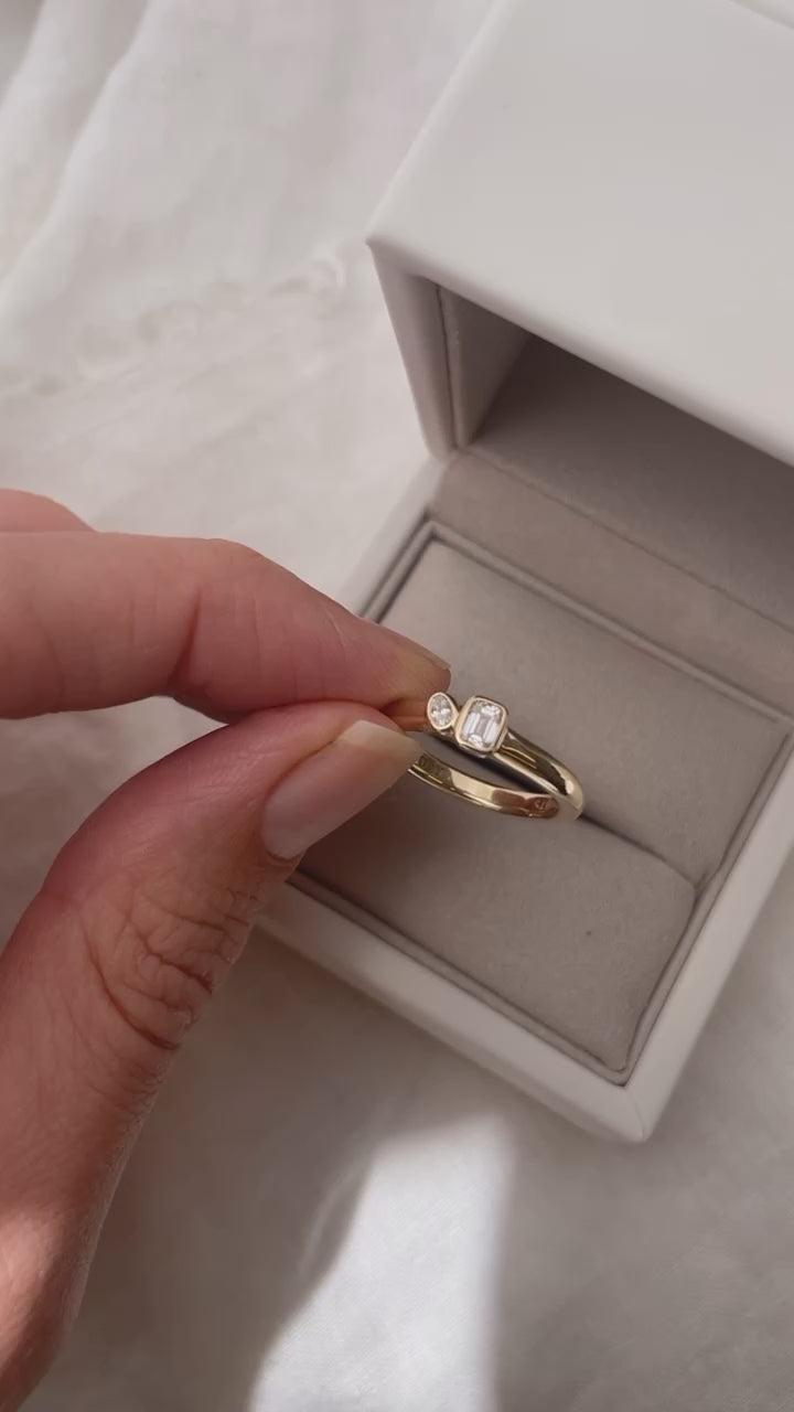 Mini Oval and Emerald Toi et Moi ring featuring bezel set oval and emerald diamonds, cast in solid Gold. Mindful jewellery and unique engagement rings for the modern woman and bride. Made in Sydney Australia 