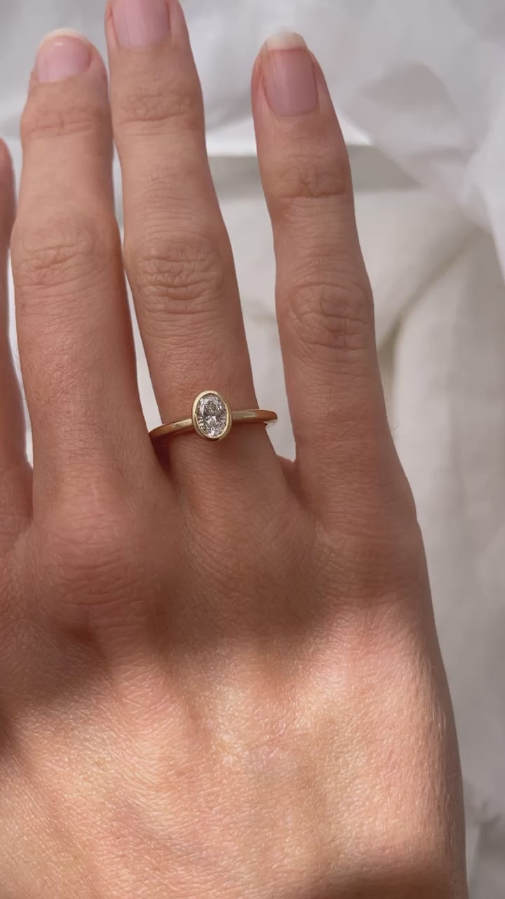 Load video: Hand carved bezel set Solitaire ring, cast in solid Gold. Handcrafted to order in Sydney Australia. Minimal Diamond Engagement ring ideal for stacking with other bands. Custom engagement and wedding rings.
