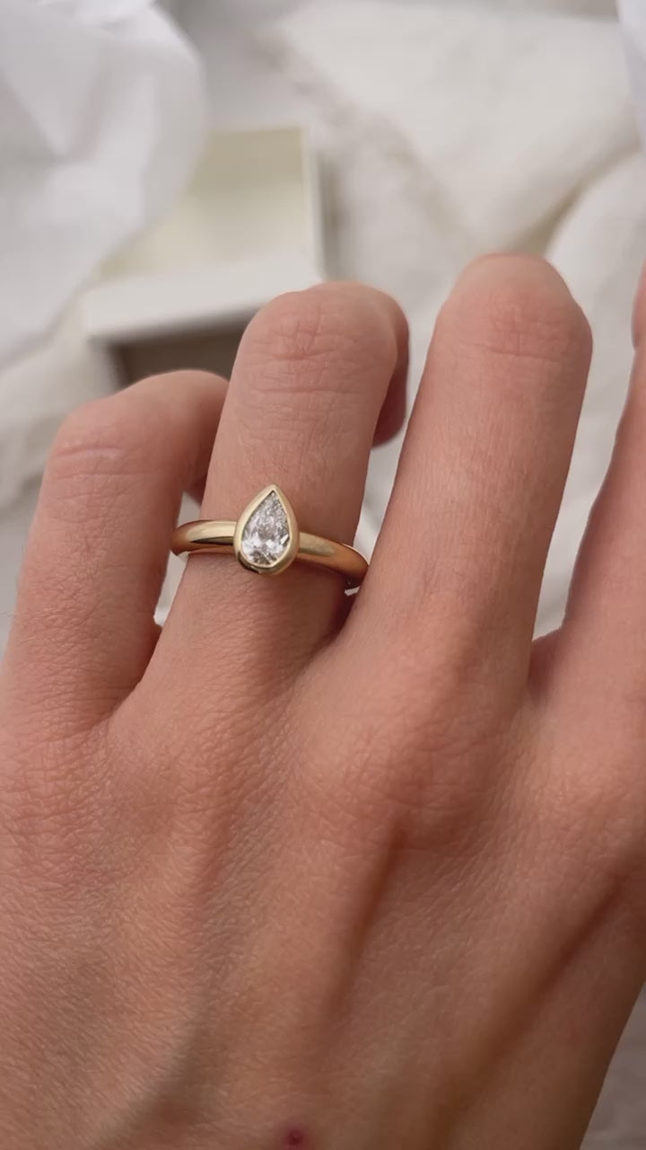 Load video: Hand carved bezel set Solitaire ring, cast in solid Gold. Handcrafted to order in Sydney Australia. Minimal Diamond Engagement ring ideal for stacking with other bands. Custom engagement and wedding rings.
